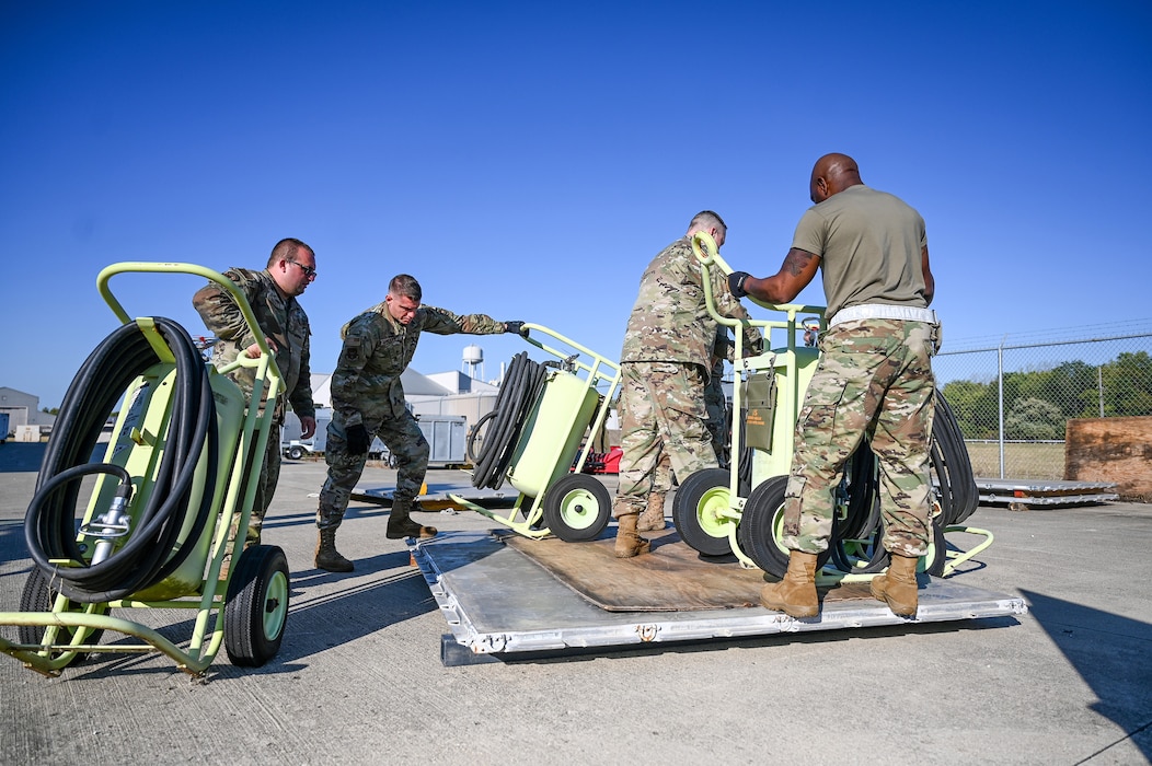 Members of the 445th Logistics Readiness Squadron and 445th Maintenance Squadron aerospace ground equipment secure six 150-pound halon fire extinguishers during pallet building training at Wright-Patterson Air Force Base, Ohio, Sept. 15, 2024.