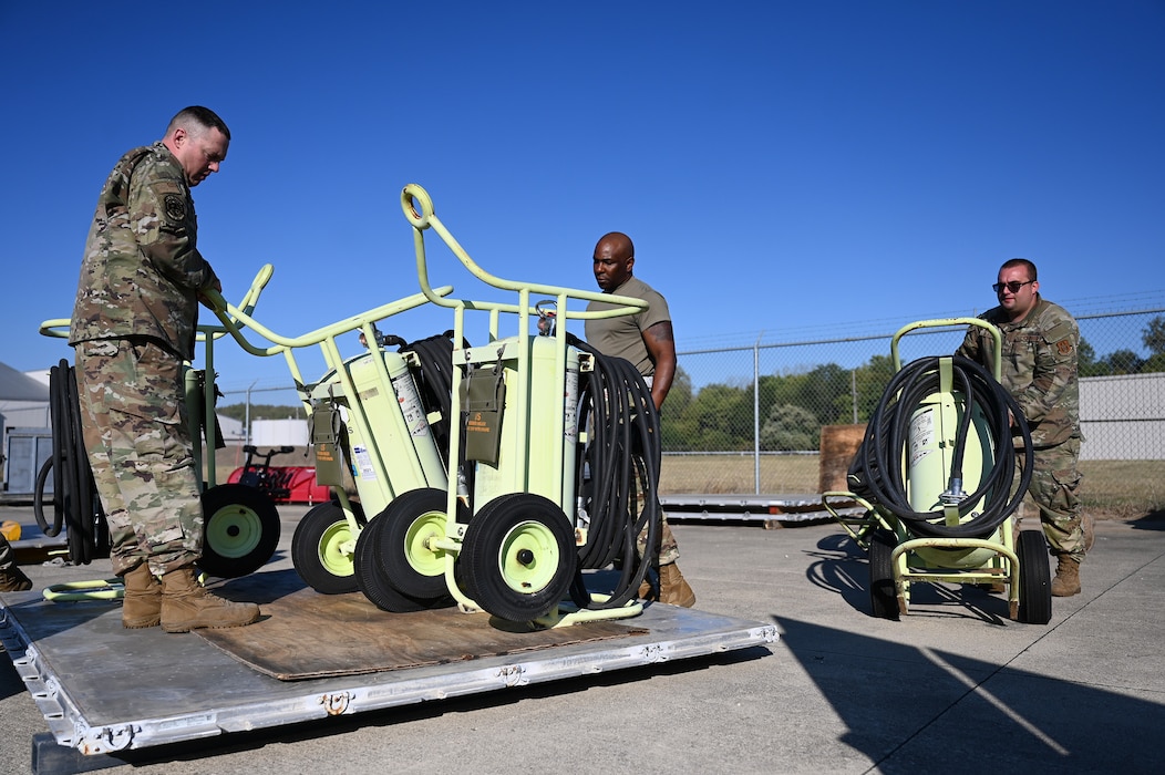 Members of the 445th Logistics Readiness Squadron and 445th Maintenance Squadron aerospace ground equipment secure six 150-pound halon fire extinguishers during pallet building training at Wright-Patterson Air Force Base, Ohio, Sept. 15, 2024.