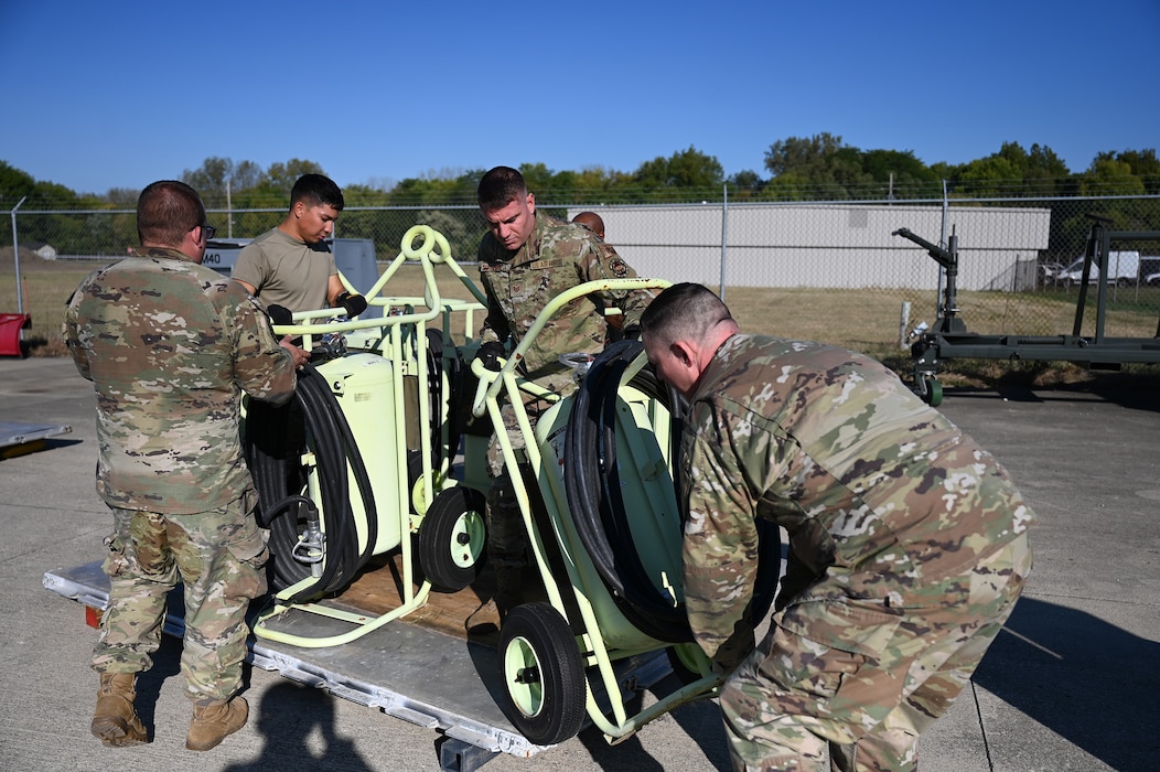 Members of the 445th Logistics Readiness Squadron and 445th Maintenance Squadron aerospace ground equipment secure six 150-pound halon fire extinguishers during pallet building training at Wright-Patterson Air Force Base, Ohio, Sept. 15, 2024.