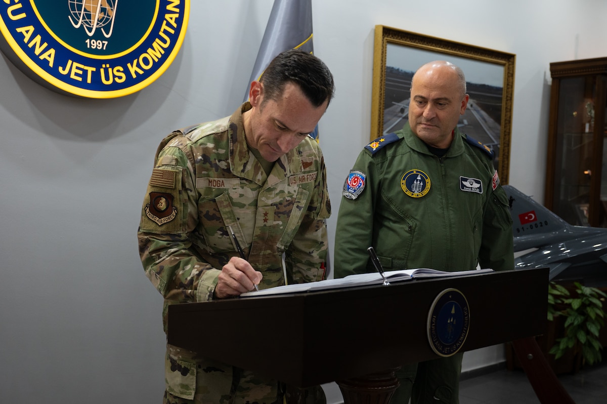 U.S. Air Force Maj. Gen. Paul Moga, Third Air Force commander, signs a visitor’s book next to Turkish air force Brig. Gen. Kemel Güleç, 10th Main Jet Base Command commander, at Incirlik Air Base, Türkiye, Oct. 3, 2024. Moga met with Güleç and had discussions focused on the longstanding U.S.-Türkiye partnership, emphasizing NATO collaboration and shared security goals. (U.S. Air Force photo by Staff Sgt. Suzie Plotnikov)
