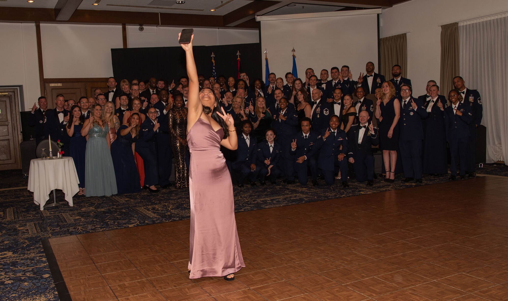 Sophia takes a selfie with a group of Airmen