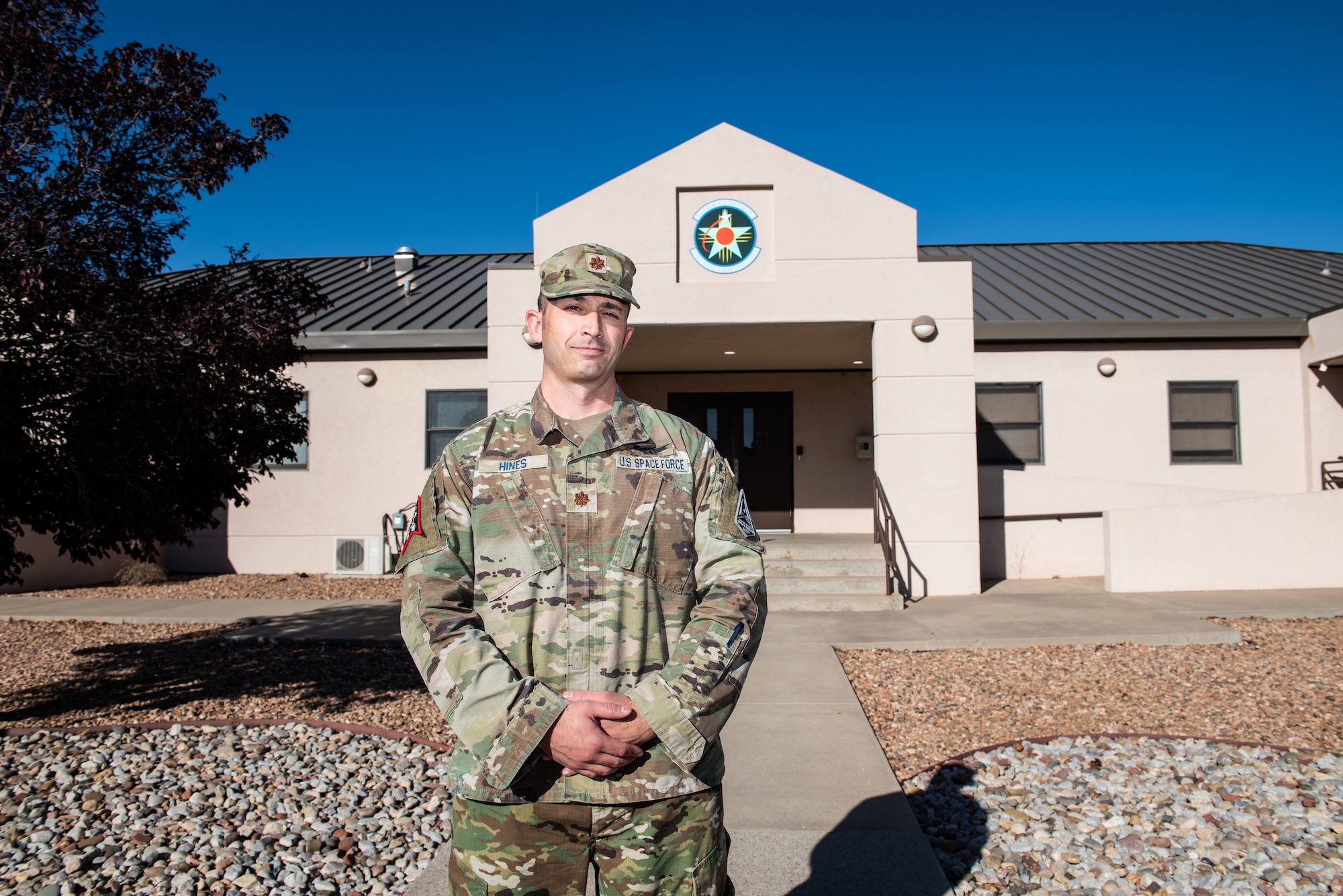 Space Force Guardian poses in uniform in front of the Space RCO office on Kirtland Air Force Base