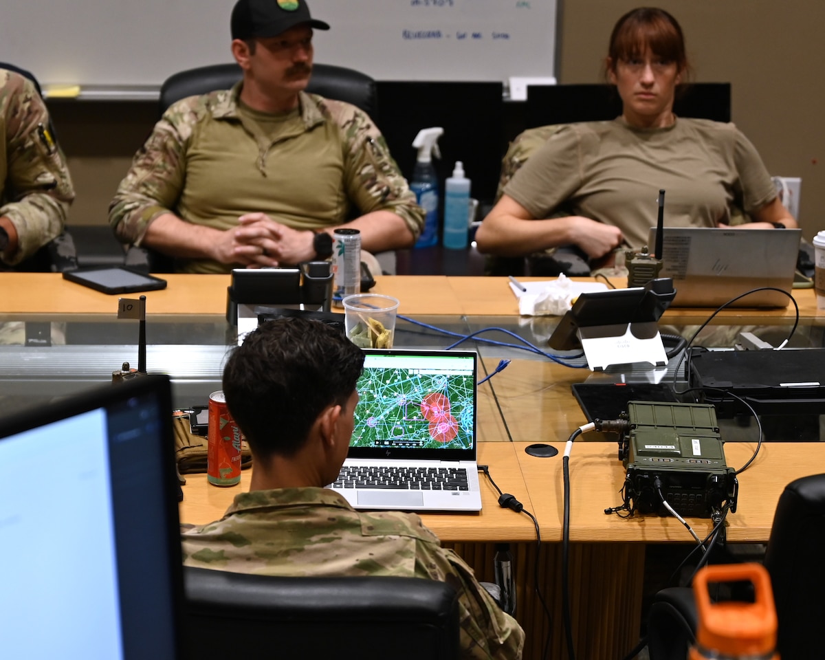 U.S. Airmen assigned to the 55th Rescue Squadron, forward deployed as the 563rd Personnel Recovery Task Force, conduct mission planning at McGhee Tyson Air National Guard Base, Tennessee, Oct. 2, 2024, in support of the U.S. Northern Command and Air Forces Northern, Defense Support of Civil Authorities Disaster Relief mission. Rescue assets from Davis-Monthan Air Force Base, Arizona are on standby to conduct rescue and recovery operations for civilians impacted by Hurricane Helene. (U.S. Air Force photo by Staff Sgt. Abbey Rieves)