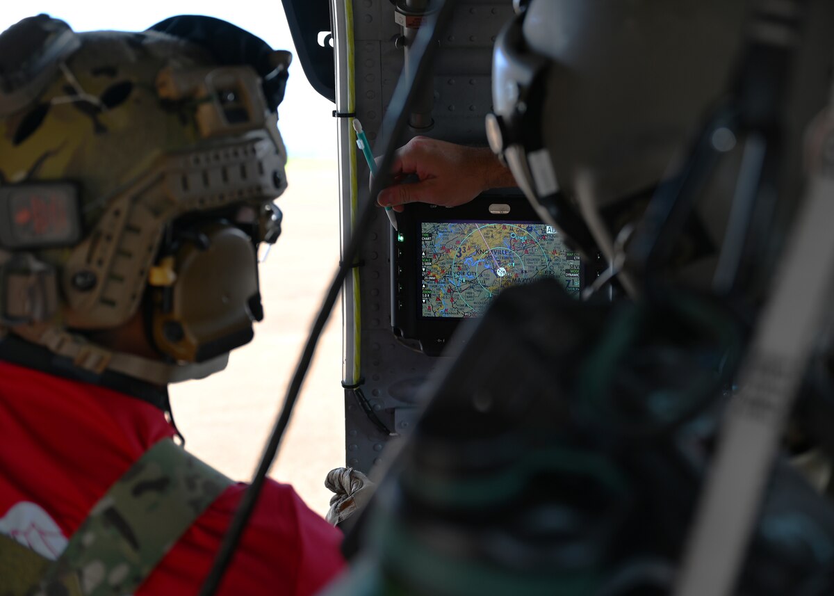 U.S. Airmen assigned to the 48th Rescue Squadron and 55th Rescue Squadron, forward deployed as the 563rd Personnel Recovery Task Force, discuss a flight route at various locations in Tennessee, Oct. 2, 2024, in support of the U.S. Northern Command and Air Forces Northern, Defense Support of Civil Authorities Disaster Relief mission. The 563rd PRTF conducted mission rehearsals in preparation for rescue and recovery operations to serve residents impacted by Hurricane Helene. (U.S. Air Force photo by Staff Sgt. Abbey Rieves)