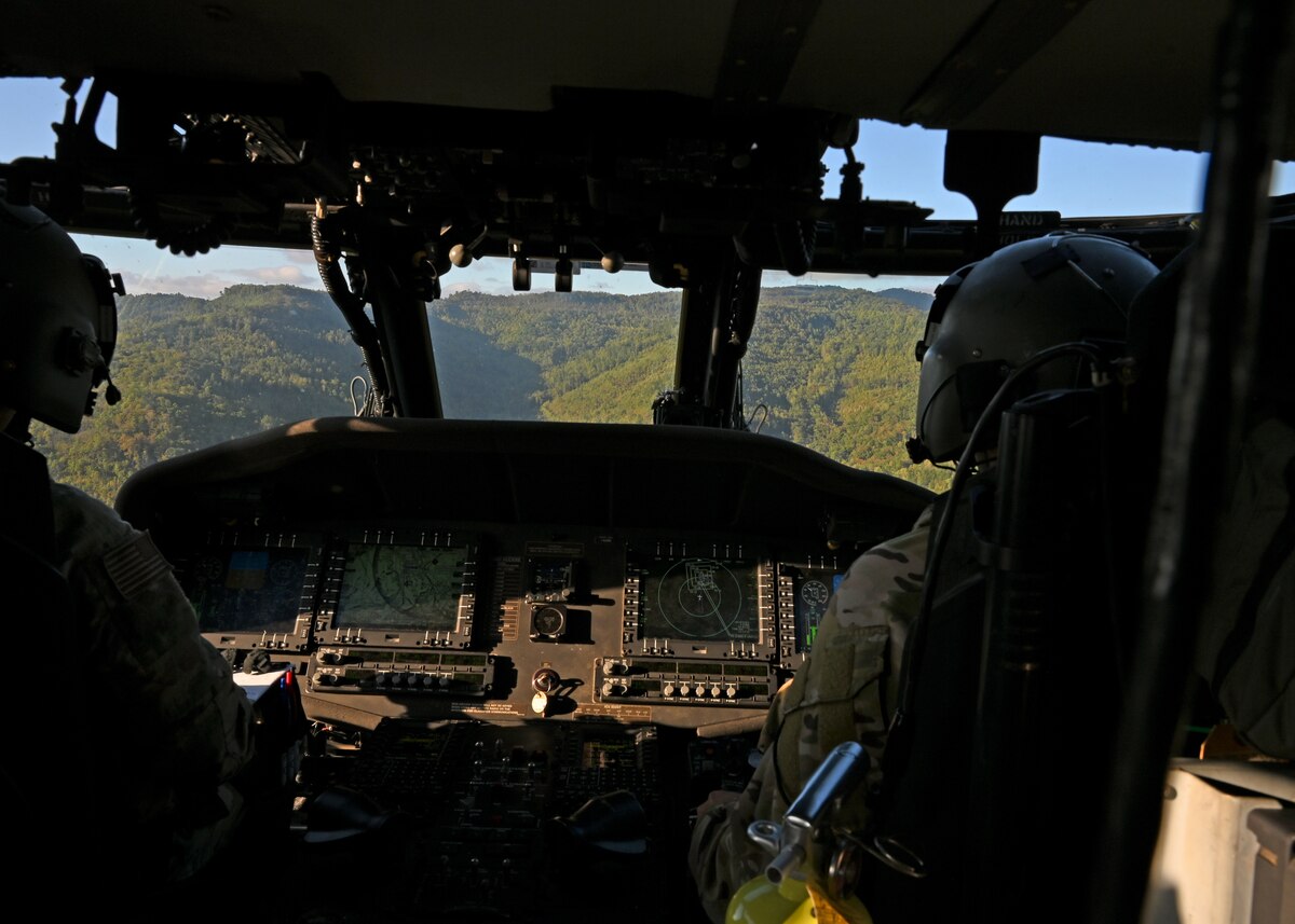U.S. Airmen assigned to the 55th Rescue Squadron, forward deployed as the 563rd Personnel Recovery Task Force, fly an HH-60W Jolly Green II helicopter over various locations in Tennessee, Oct. 2, 2024, in support of the U.S. Northern Command and Air Forces Northern, Defense Support of Civil Authorities Disaster Relief mission. Rescue assets from Davis-Monthan Air Force Base, Arizona practiced rescue and recovery operations to serve residents impacted by Hurricane Helene. (U.S. Air Force photo by Staff Sgt. Abbey Rieves)