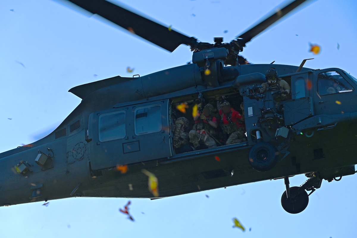 An HH-60W Jolly Green II helicopter assigned to the 55th Rescue Squadron, forward deployed in the 563rd Personnel Recovery Task Force, trains rescue techniques at various locations in Tennessee, Oct. 2, 2024, in support of the U.S. Northern Command and Air Forces Northern, Defense Support of Civil Authorities Disaster Relief mission. USNORTHCOM has well established contingency plans that account for natural and man-made events and allows the Department of Defense to execute its homeland defense mission without interruption. (U.S. Air Force photo by Staff Sgt. Abbey Rieves) (Note this photo has been altered for security purposes by blurring out facial identification.)