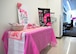 A Breast Cancer Awareness table is set up at Wilford Hall Mammography Clinic, JBSA-Lackland, Texas, on October 3, 2024, with information and pink decor.