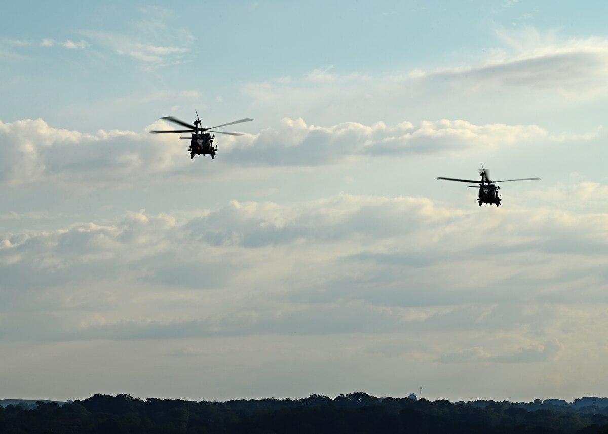 Two HH-60W Jolly Green II helicopters assigned to the 55th Rescue Squadron, forward deployed in the 563rd Personnel Recovery Task Force, launch for search and rescue operations from McGhee Tyson Air National Guard Base, Tennessee, Oct. 3, 2024, in support of the U.S. Northern Command and Air Forces Northern, Defense Support of Civil Authorities Disaster Relief mission. U.S. Airmen operate on Title 10 orders to provide necessary support to civilian authorities during natural disasters when directed and approved by the Secretary of Defense. (U.S. Air Force photo by Staff Sgt. Abbey Rieves)