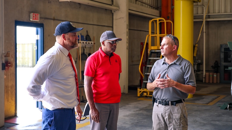 U.S. Rep. Aaron Bean, R-Fla., speaks with retired Marine Corps Maj. Thurman Bobbett, head of maintenance management branch, and retired Marine Corps Master Sgt. Jim Maddox, motor transportation section supervisor, during a visit Aug. 8, 2024, to Marine Corps Support Facility Blount Island in Florida.