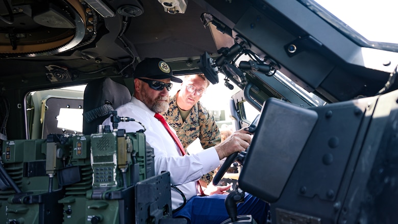U.S. Marine Corps Cpl. Mitchell Prochnow of Bloomington, Illinois, shows Rep. Aaron Bean, R-Fla., a Joint Light Tactical Vehicle during the congressman's visit Aug. 8 to Marine Corps Support Facility Blount Island in Florida.