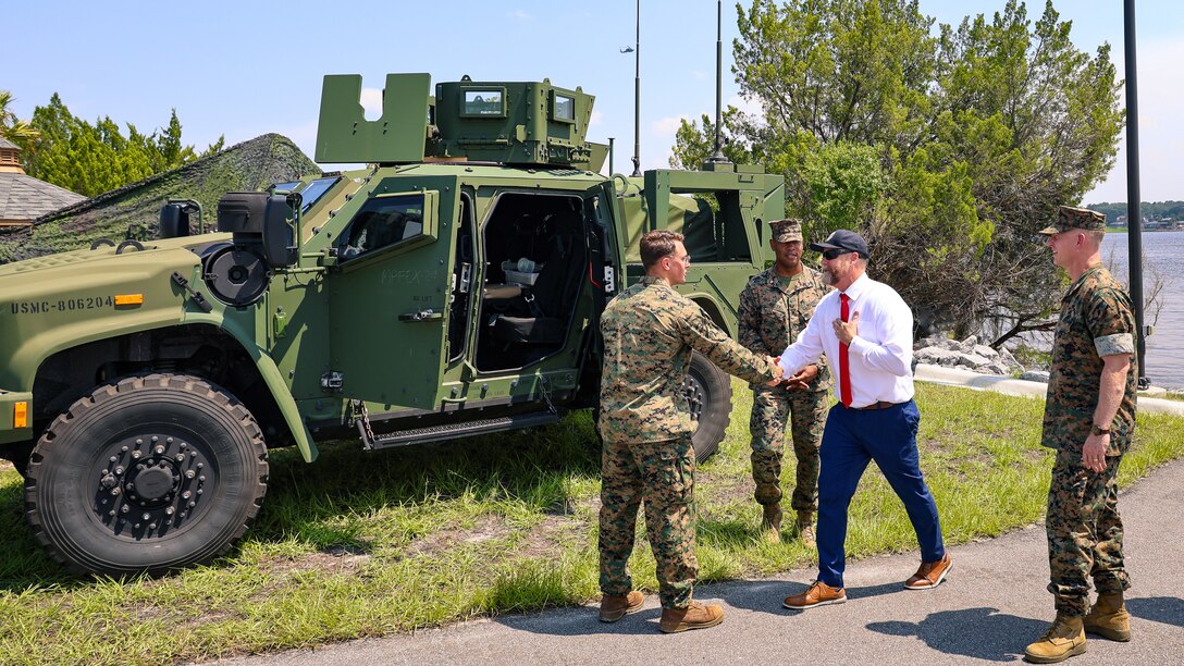U.S. Marine Corps Cpl. Mitchell Prochnow of Bloomington, Illinois, greets Rep. Aaron Bean, R-Fla., during the congressman's visit Aug. 8, 2024, to Marine Corps Support Facility Blount Island in Florida.
