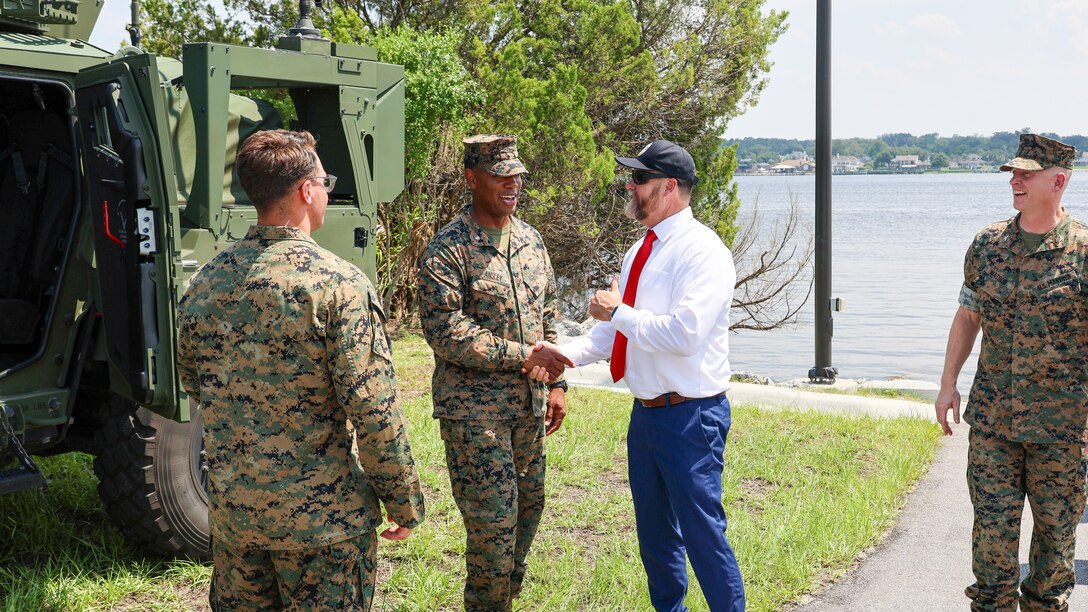 U.S. Marine Corps Lt. Col. Anthony Ansley, commanding officer, Combat Logistics Battalion 22, 2nd Marine Logistics Group, greets Rep. Aaron Bean, R-Fla., during the congressman's visit Aug. 8, 2024, to Marine Corps Support Facility Blount Island in Florida.