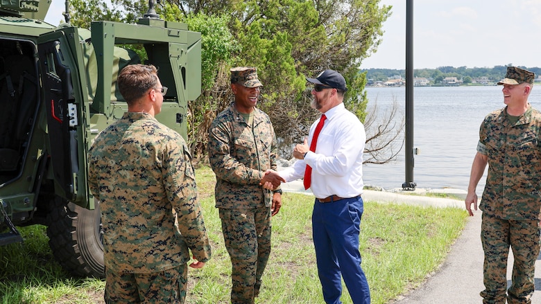 U.S. Marine Corps Lt. Col. Anthony Ansley, commanding officer, Combat Logistics Battalion 22, 2nd Marine Logistics Group, greets Rep. Aaron Bean, R-Fla., during the congressman's visit Aug. 8, 2024, to Marine Corps Support Facility Blount Island in Florida.