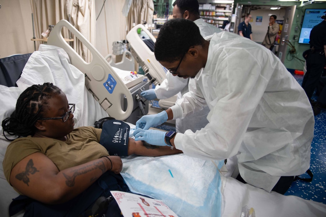 240816-N-DE539-1025 OKINAWA, JAPAN (August 16, 2024) Seaman Victoria Blue (left), assigned to the amphibious transport dock ship USS Green Bay (LPD 20) has her blood drawn by Hospital Corpsman 2nd Class David Player (right), during a blood drive. USS Green Bay, part of the America Amphibious Ready Group, is operating in the U.S. 7th Fleet area of operations. Consisting of 400 Sailors and Officers and the capacity to embark up to 800 Marines, the USS Green Bay’s mission is to transport and launch amphibious craft in support of Amphibious Warfare and Humanitarian Operations. (U.S. Navy photo by Mass Communication Specialist 2nd Class Alexander Timewell)