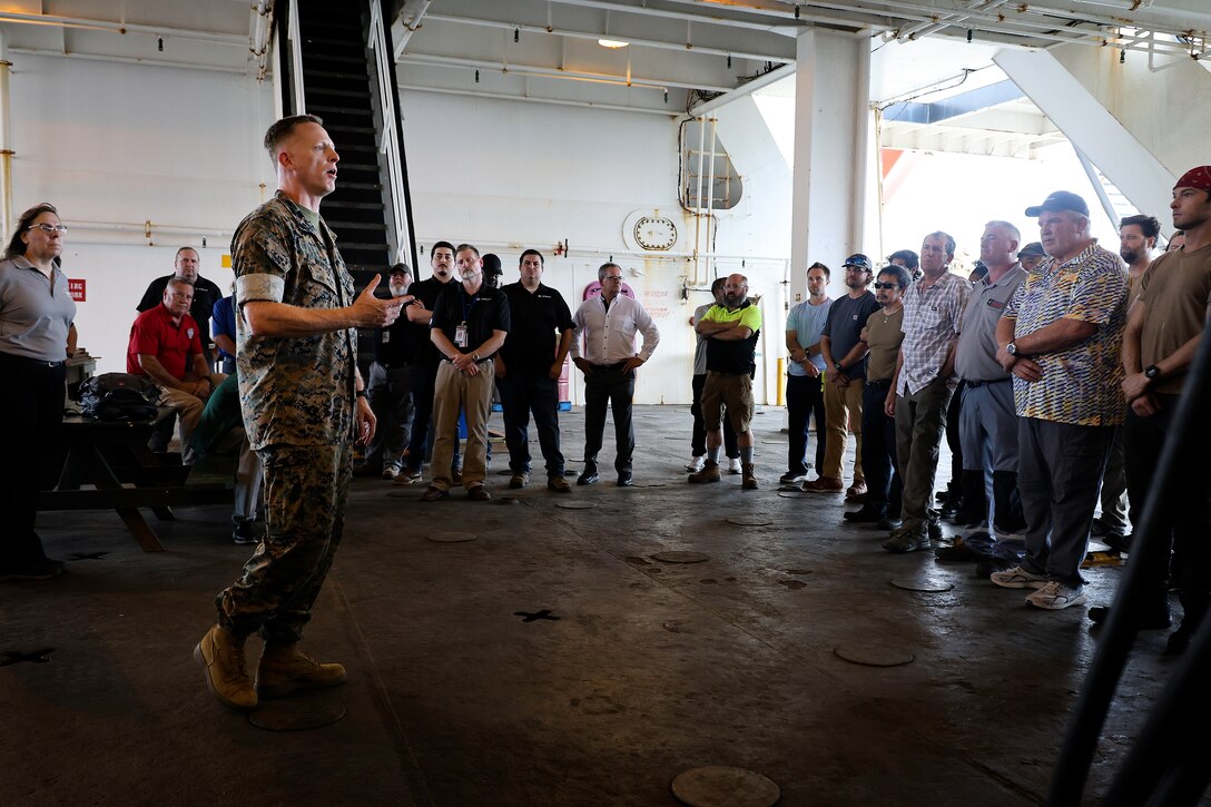U.S. Marine Corps Col. Luke Watson, commanding officer, Blount Island Command, expresses his gratitude Aug. 22, 2024, while aboard the USNS GySgt. Fred W. Stockham at Marine Corps Support Facility Blount Island in Florida. USNS 1st Lt. Baldomero Lopez and USNS Stockham deployed in March and April, respectively, as part of a whole-of-government humanitarian response to the October 2023 terrorist attacks that killed more than 1,000 civilians in Israel, including U.S. citizens. The U.S. Navy’s roll-on, roll-off support cargo ships offloaded more than 5,700 pallets of food, along with fuel for the Army's Joint Logistics Over-the-Shore temporary pier modules, tugs, boats and trucks. They also transported roughly 240 military personnel from Florida to Gaza. With the ships back at Blount Island, leadership teams from the U.S. Navy’s Military Sealift Command and U.S. Marine Corps’ Blount Island Command, strategic partners in the U.S. Marine Corps prepositioning mission, walked aboard USNS Stockham to thank the captains and their crews. An executive team from Crowley Government Solutions, contracted to operate and maintain the massive vessels, highlighted numerous individual efforts that were critical to the response effort.