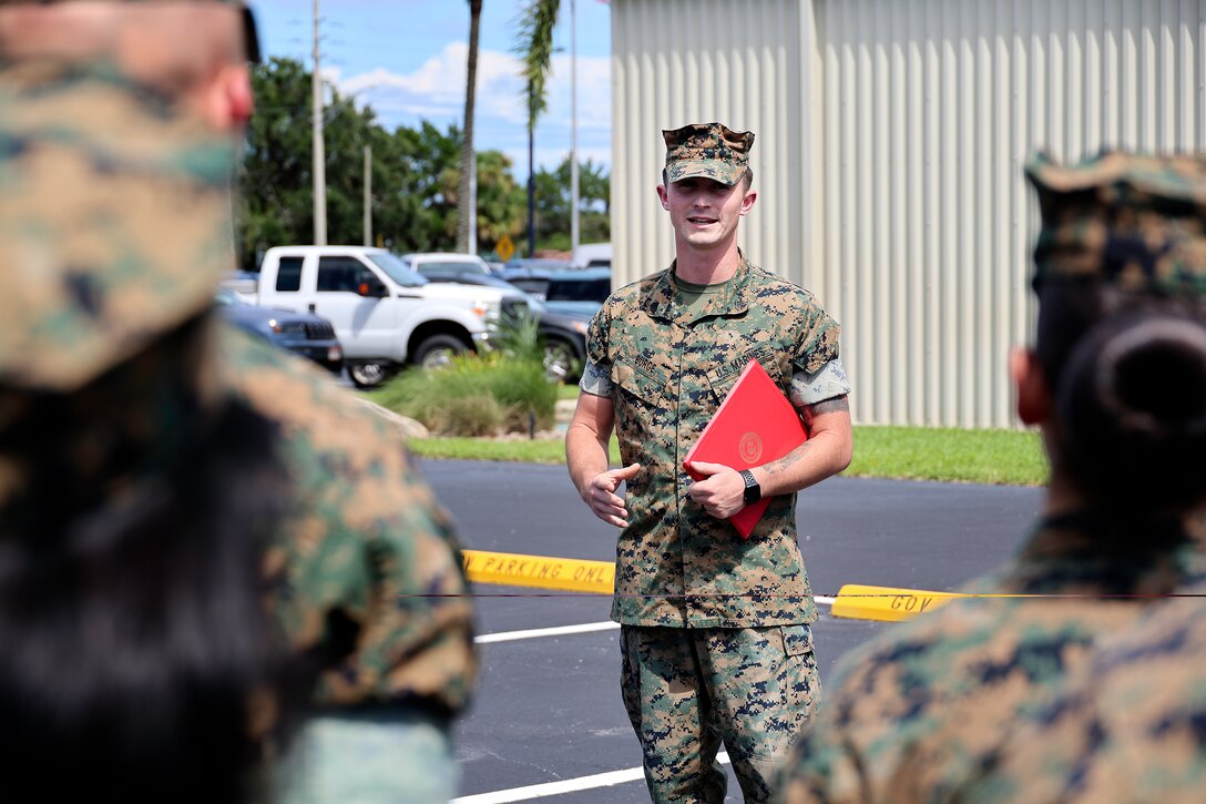 U.S. Marine Corps Sgt. Dylan Burge of Lawrenceville, Ga., speaks with Marines after receiving a certification of commendation during a formation Aug. 26, 2024, at Marine Corps Support Facility Blount Island in Florida. Burge earned noncommissioned officer of the quarter for Marine Corps Logistics Command (LOGCOM), headquartered in Albany, Ga. “Throughout the quarter, Sgt. Burge continually set the example for his peers by demonstrating outstanding leadership, extraordinary commitment to mission accomplishment and exceptional strength of character,” said Maj. Gen. Keith Reventlow, commanding general, LOGCOM, in the commendation certificate. Burge reported to boot camp in June 2018, soon after graduating from high school. He currently serves as Blount Island Command individual material readiness list manager, as well as career planner. “You’re a Marine on and off the clock, so use every moment to make yourself better,” said Burge, facing the company of Marines in Florida. He said earning the distinction doesn’t change anything, adding, “what’s most important is being able to work with these guys every day.”