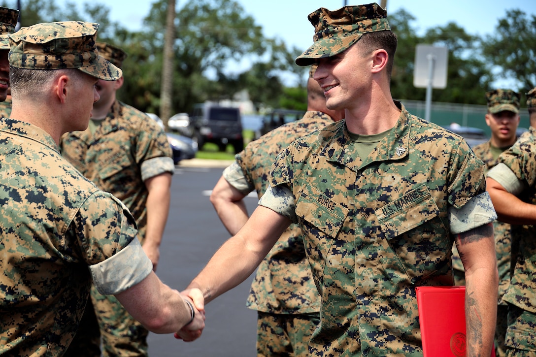 U.S. Marines from Blount Island Command congratulate Sgt. Dylan Burge of Lawrenceville, Ga., after he received a certification of commendation during a formation Aug. 26, 2024, at Marine Corps Support Facility Blount Island in Florida. Burge earned noncommissioned officer of the quarter for Marine Corps Logistics Command (LOGCOM), headquartered in Albany, Ga. “Throughout the quarter, Sgt. Burge continually set the example for his peers by demonstrating outstanding leadership, extraordinary commitment to mission accomplishment and exceptional strength of character,” said Maj. Gen. Keith Reventlow, commanding general, LOGCOM, in the commendation certificate. Burge reported to boot camp in June 2018, soon after graduating from high school. He currently serves as Blount Island Command individual material readiness list manager, as well as career planner.  “You’re a Marine on and off the clock, so use every moment to make yourself better,” said Burge, facing the company of Marines in Florida. He said earning the distinction doesn’t change anything, adding, “what’s most important is being able to work with these guys every day.”