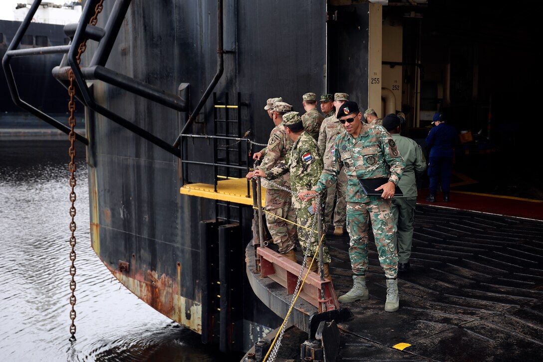 Students from Western Hemisphere Institute for Security Cooperation board the USNS 1st Lt. Baldomero Lopez during a tour Sept. 13, 2024, at Marine Corps Support Facility Blount Island in Florida. Of the nearly 60 students from the military education and training institute in Fort Moore, Georgia, roughly half were staff officers from a dozen partner nations spanning from Mexico through South America. After learning about military equipment and staging areas, the students toured USNS Lopez, a U.S. Navy roll-on, roll-off support cargo ship operated by Military Sealift Command. The 1,100-acre Marine Corps facility, located along the St. Johns River in northeast Florida, is the hub of Marine Corps’ prepositioning programs. Blount Island Command personnel—service members, government civilians and federal contractors—ensure Marines responding to global contingency areas are supported with the highest quality combat-ready equipment and supplies.