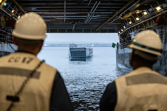 Sailors aboard USS Somerset (LPD 25) monitor an approaching  landing craft, utility, from ACU-1 while underway in the Pacific Ocean.