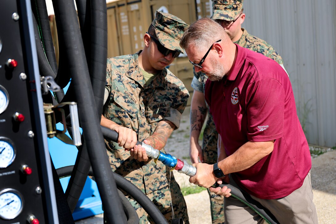 Marine Corps Sgt. Joseph Sortman of Long Beach, California, is trained on polyalphaolefin fluid servicing carts, which cool F-35 aircraft mission systems, by Bill Pawlowski, Lockheed Martin senior field engineer, Sept. 24, 2024, at Marine Corps Support Facility Blount Island in Florida. The facility, located along the St. Johns River in northeast Florida, is the hub of Marine Corps’ prepositioning programs. With the transition to the F-35 offering advanced stealth and sensor capabilities in a long-range fighter platform, the aircraft’s ground support equipment is now a maritime prepositioning force asset—it must be strategically positioned with other combat-ready equipment and supplies. Technical subject-matter experts arrived at the facility in Florida for the induction. While contractors maintain the equipment, Marines must conduct in-process inspections, ensuring adherence to approved ground operations procedures. “We make sure everything is maintained correctly and safely,” said Sortman, ground support equipment quality assurance representative at Blount Island Command.