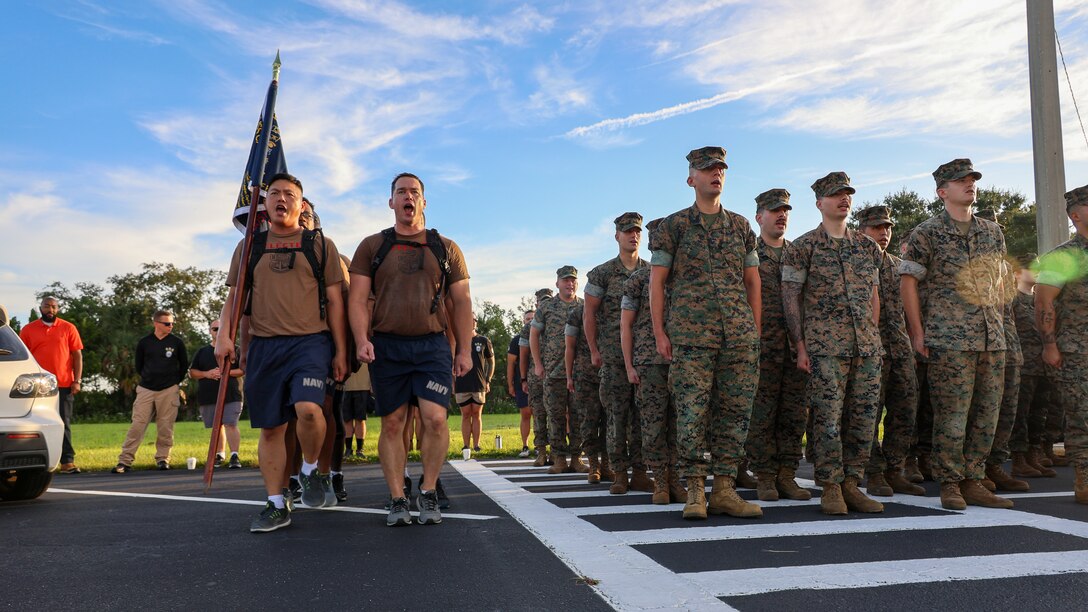 Sailors assigned to the U.S. Navy destroyer USS Carney, homeported at Naval Station Mayport in Jacksonville, sing the “The Marines’ Hymn” while completing chief petty officer initiation capstone events Sept. 25 at Marine Corps Support Facility Blount Island in Florida.