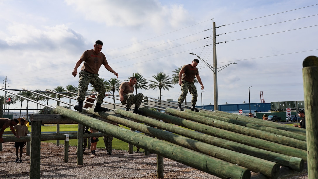 Sailors assigned to the U.S. Navy destroyer USS Carney, homeported at Naval Station Mayport in Jacksonville, traverse an obstacle course while completing chief petty officer initiation capstone events Sept. 25 at Marine Corps Support Facility Blount Island in Florida.