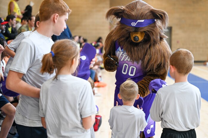 Jazz Bear signs autographs for a group of children.