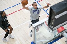 Preston jumps to dunk a ball.