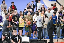 Clarkson signs autographs for military families.