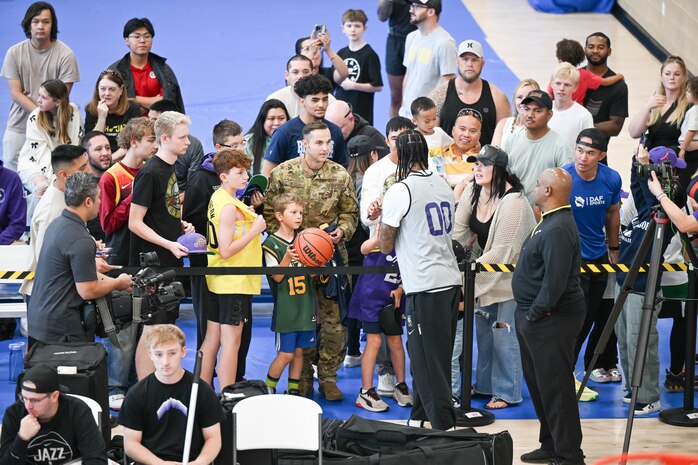 Clarkson signs autographs for military families.