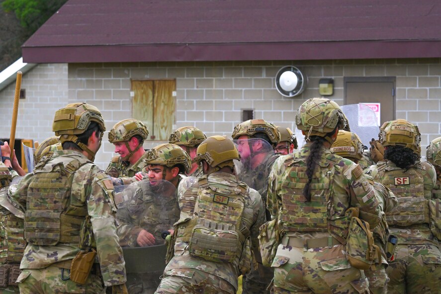Airmen assigned to the 891st Missile Security Forces Squadron perform simulated riot control during Operation Cerberus at Camp Ripley, Minnesota, Sept. 24, 2024. The riot control training familiarized the Airmen with riot control equipment, preparation and tactics.