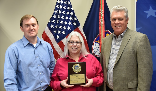 Scott A. Meyerhoff and Monica A. Dumont, U.S. Army Space and Missile Defense Command’s Space and Missile Defense Center of Excellence operations research systems analysts; and Martin S. Goodman, chief of the Studies and Analysis Branch within the SMD CoE Decision Support Division, recently received an Army Operational Analysis Award. The award recognizes the most consequential analytical effort in support of operational commanders planning and/or conducting current operations, security cooperation activities, or major exercises, and executed by analysts assigned to operational headquarters; brigade, division and corps staffs, or Army service component commands. (U.S. Army photo by Jason B. Cutshaw)