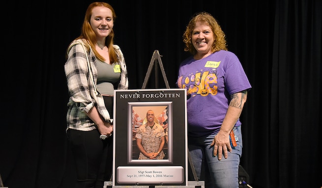 Sarah Bowen, right, and her daughter, Kaitlyn, pose with a poster honoring their fallen service member, Marine Staff Sgt. Scott Bowen, Sarah’s husband and Kaitlyn’s father. Bowen has been a member of Redstone Arsenal’s Survivor Outreach Services since July 2016. (U.S. Army photo by Carrie David Campbell)