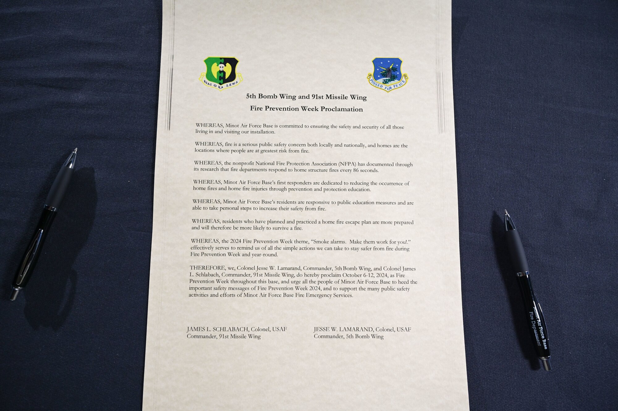 The 5th Bomb Wing and the 91st Missile Wing Fire Prevention Week Proclamation awaits signatures from U.S. Air Force Col. Jesse Lamarand, 5th Bomb Wing (5 BW) commander, and Col. James Schlabach, 91st Missile Wing (91 MW) commander, on Sept. 30, 2024, Minot Air Force Base, North Dakota. Fire Prevention Week is a time focused on raising public awareness about fire safety.