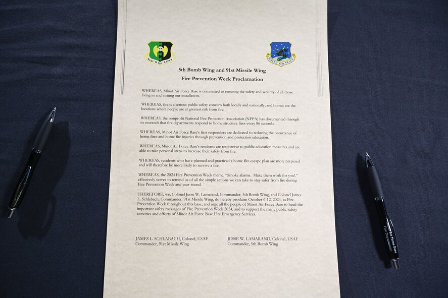 The 5th Bomb Wing and the 91st Missile Wing Fire Prevention Week Proclamation awaits signatures from U.S. Air Force Col. Jesse Lamarand, 5th Bomb Wing (5 BW) commander, and Col. James Schlabach, 91st Missile Wing (91 MW) commander, on Sept. 30, 2024, Minot Air Force Base, North Dakota. Fire Prevention Week is a time focused on raising public awareness about fire safety.