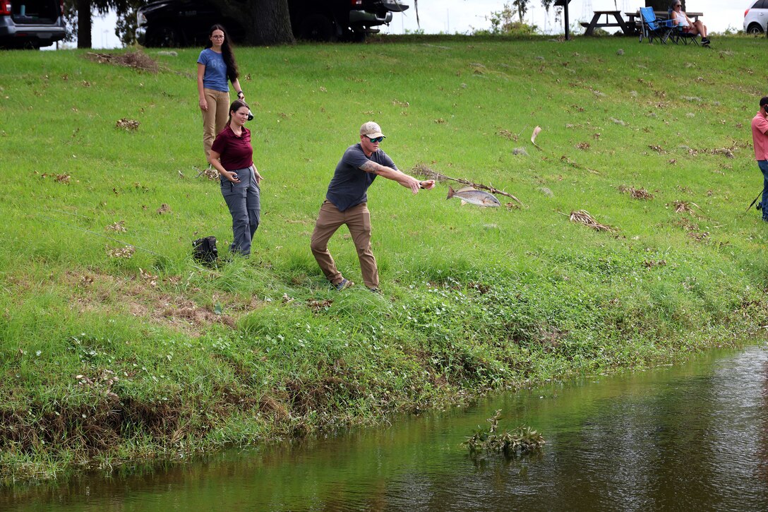 U.S. Navy Petty Officer First Class Brad Witherell of Slidell, Louisiana, tosses a redfish during a quarterly catch-and-release tournament Oct. 3, 2024, at Marine Corps Support Facility Blount Island in Florida.