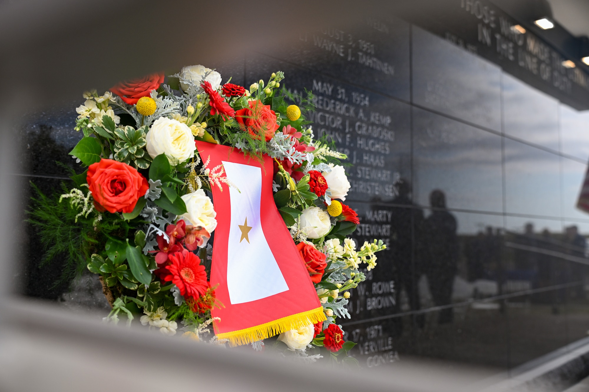 The wreath displayed to honor the fallen services members and their gold star family’s at the 148th Fighter Wing’s memorial wall dedication ceremony on Oct. 5, 2024. The newly completed memorial wall honors 21 fallen service members who were lost while conducting their military duties over the wing’s 76-year history. (U.S. Air National Guard photo by Staff. Sgt. Tylin Rust)