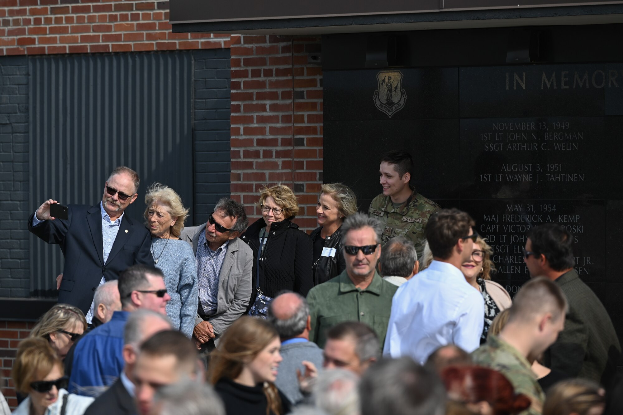Family members of fallen service member 1st Lieutenant Wayne Tahtinen gather at the 148th Fighter Wing memorial wall dedication ceremony Oct. 5, 2024. The newly completed memorial wall honors 21 fallen service members who were lost while conducting their military duties over the wing’s 76 year history. (U.S. Air National Guard photo by Master Sgt. Megan Shaner)