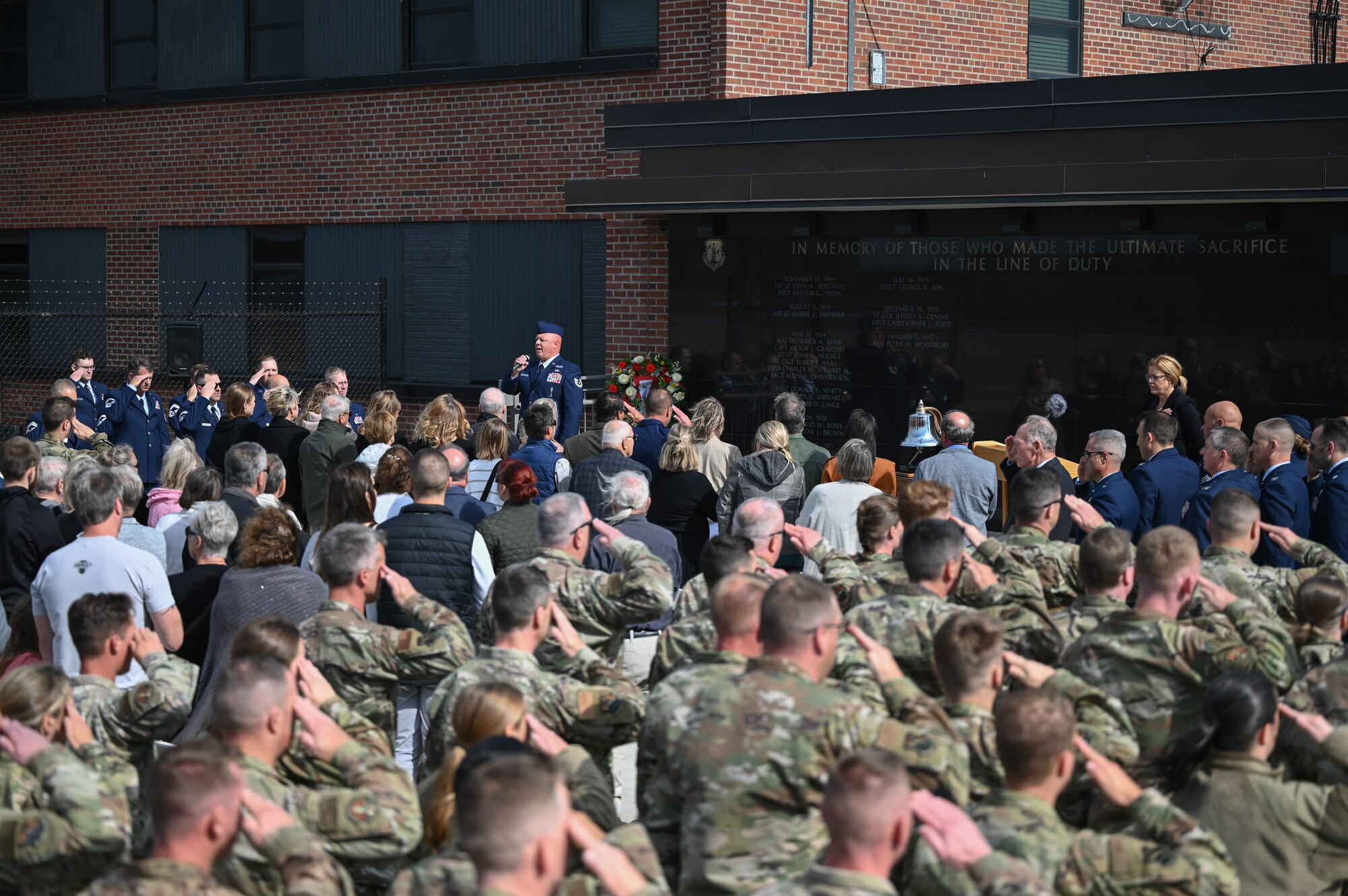 U.S. Air Force Tech. Sgt. Jared Hinks, a munitions systems specialist with the 148th Fighter Wing, Minnesota Air National Guard, sings the National Anthem at a ceremony dedicating a memorial wall at the 148th Fighter Wing in Duluth, Minn. Oct. 5, 2024. The newly completed memorial wall honors 21 fallen service members who were lost while conducting their military duties over the wing’s 76-year history. (U.S. Air National Guard photo by Master Sgt. Megan Shaner)