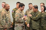 616th Operation Center leadership exchanges patches with Philippine Army leadership in a conference room.