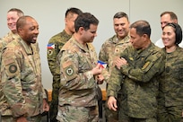 616th Operation Center leadership exchanges patches with Philippine Army leadership in a conference room.