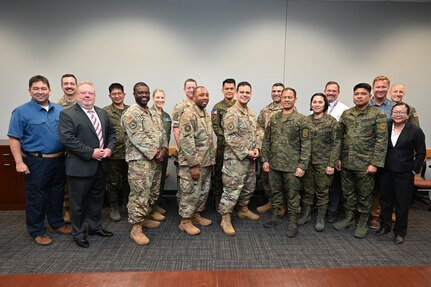 Philippine Army and 16th Air Force members pose for a group photo in a conference room.