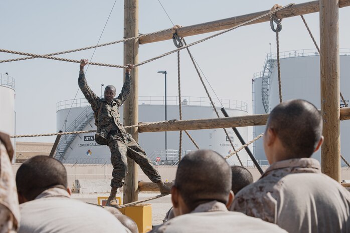 U.S. Marine Corps Sgt. Caceldric Williams Jr., a drill instructor with Golf Company, 2nd Recruit Training Battalion, demonstrates the execution of the confidence course training event at Marine Corps Recruit Depot San Diego, California, Sept. 23, 2024. The confidence course challenges recruits physically and mentally through obstacles that require confidence in their strength, balance, and determination. (U.S. Marine Corps photo by Cpl. Sarah M. Grawcock)