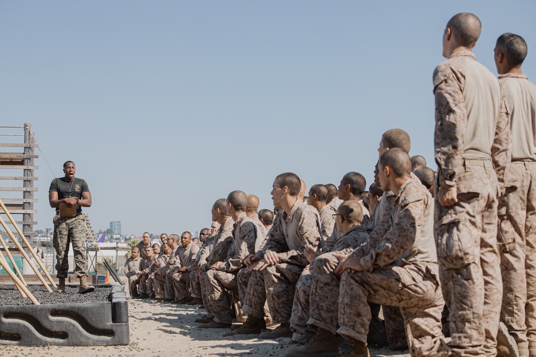 U.S. Marine Corps Sgt. Thierno Jalloh, left, a martial arts instructor with Support Battalion, Recruit Training Regiment, gives instructions to recruits with Golf Company, 2nd Recruit Training Battalion, on the execution of the confidence course at Marine Corps Recruit Depot San Diego, California, Sept. 23, 2024. The confidence course challenges recruits physically and mentally through obstacles that require confidence in their strength, balance, and determination. (U.S. Marine Corps photo by Cpl. Sarah M. Grawcock)