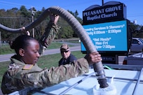 U.S. Army National Guard Spc. Diamond Espinoza, a water treatment specialist assigned to Alpha Company,169th Divisional Sustainment Support Battalion, pumps water for a resident in Mountain City, Tennessee, Oct. 6, 2024. The Tennessee National Guard continues to support the Tennessee Emergency Management Agency and the state, county and local first responders in the areas impacted by severe flooding following Hurricane Helene.