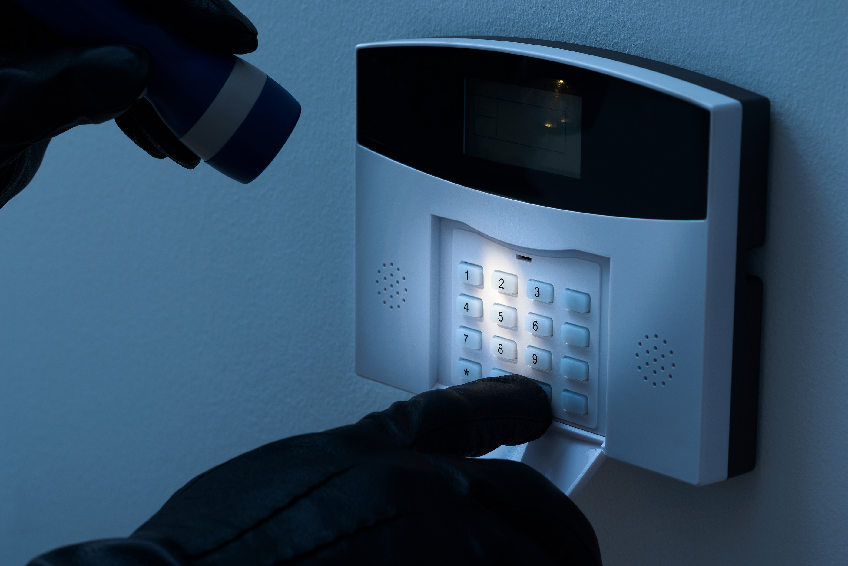 Burglar Trying To Disarm The Security Alarm System