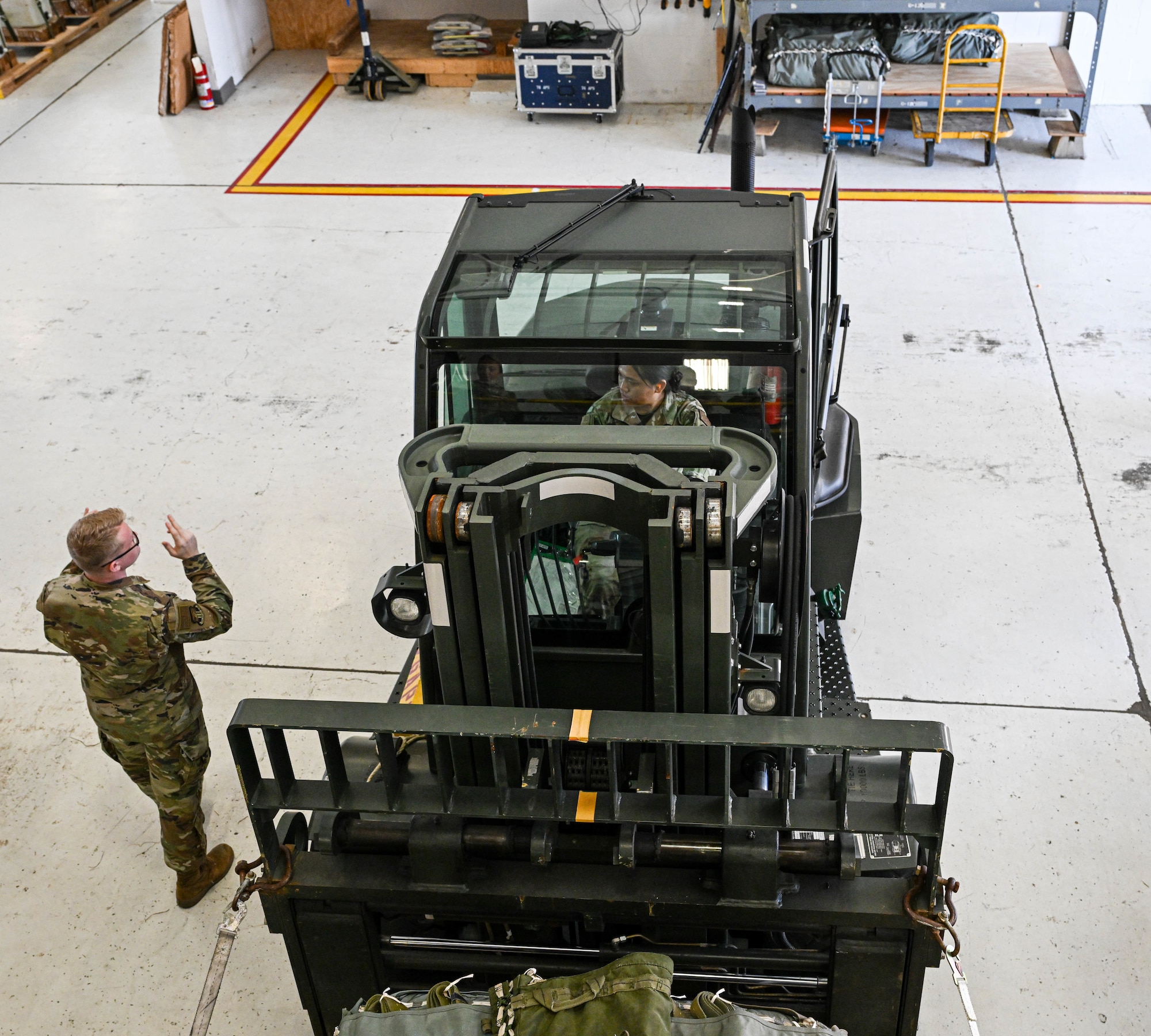 Senior Airman Logan Manej (left), a ramp operations representative and Senior Airman Ashmita Samal (right), a passenger operations representative, both with the 76th Aerial Port Squadron, work on ground guiding during a training exercise at Youngstown Air Reserve Station, Ohio, Oct. 6, 2024.