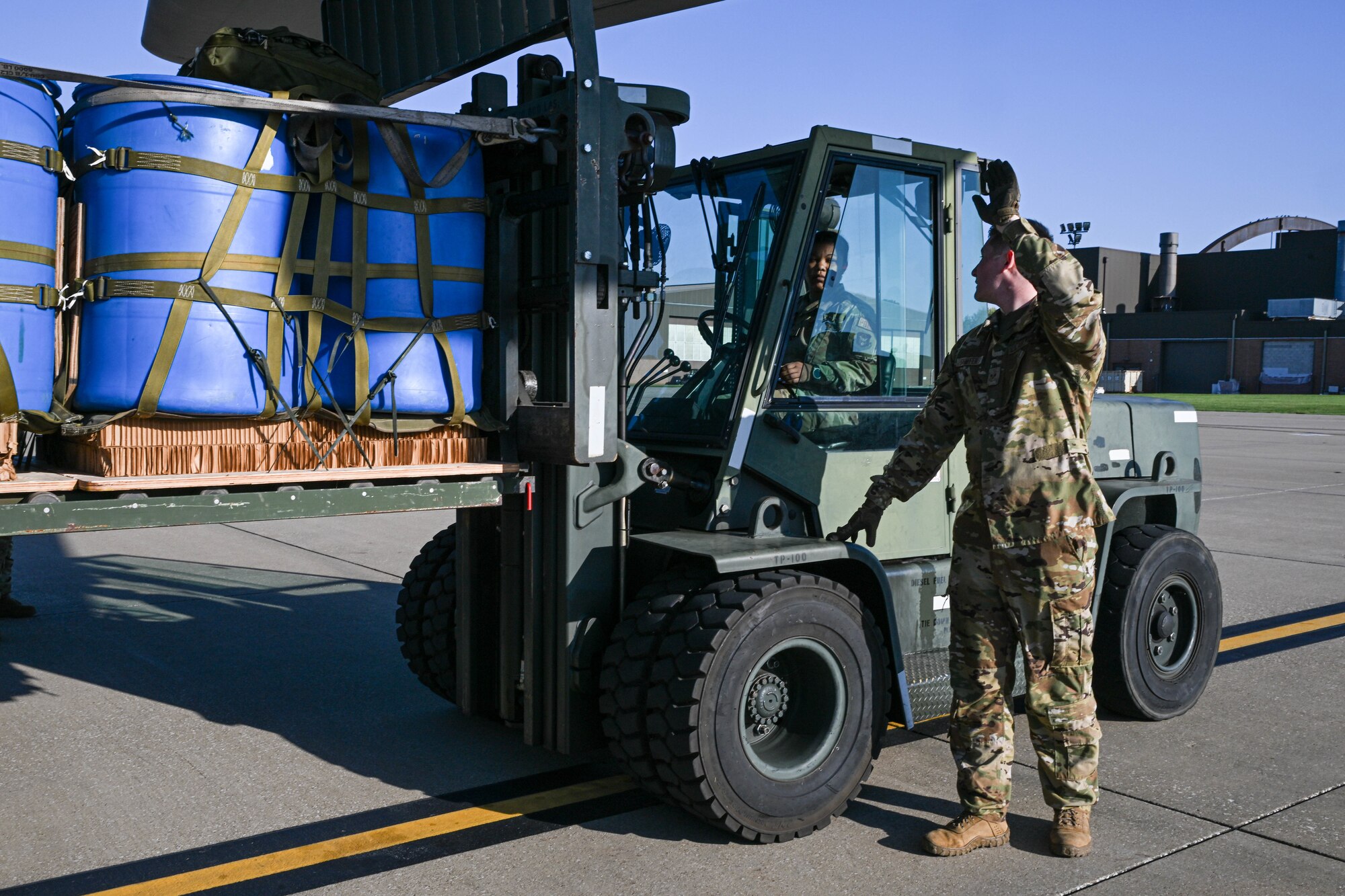 Senior Airman Marlene Ford (left), an air transportation helper with the 76th Aerial Port Squadron, is loading an airdrop training pallet into a C-130H Hercules aircraft guided by Senior Airman Jered Shaffer (right), a loadmaster with the 757th Airlift Squadron, at Youngstown Air Reserve Station, Ohio, Oct. 6, 2024.