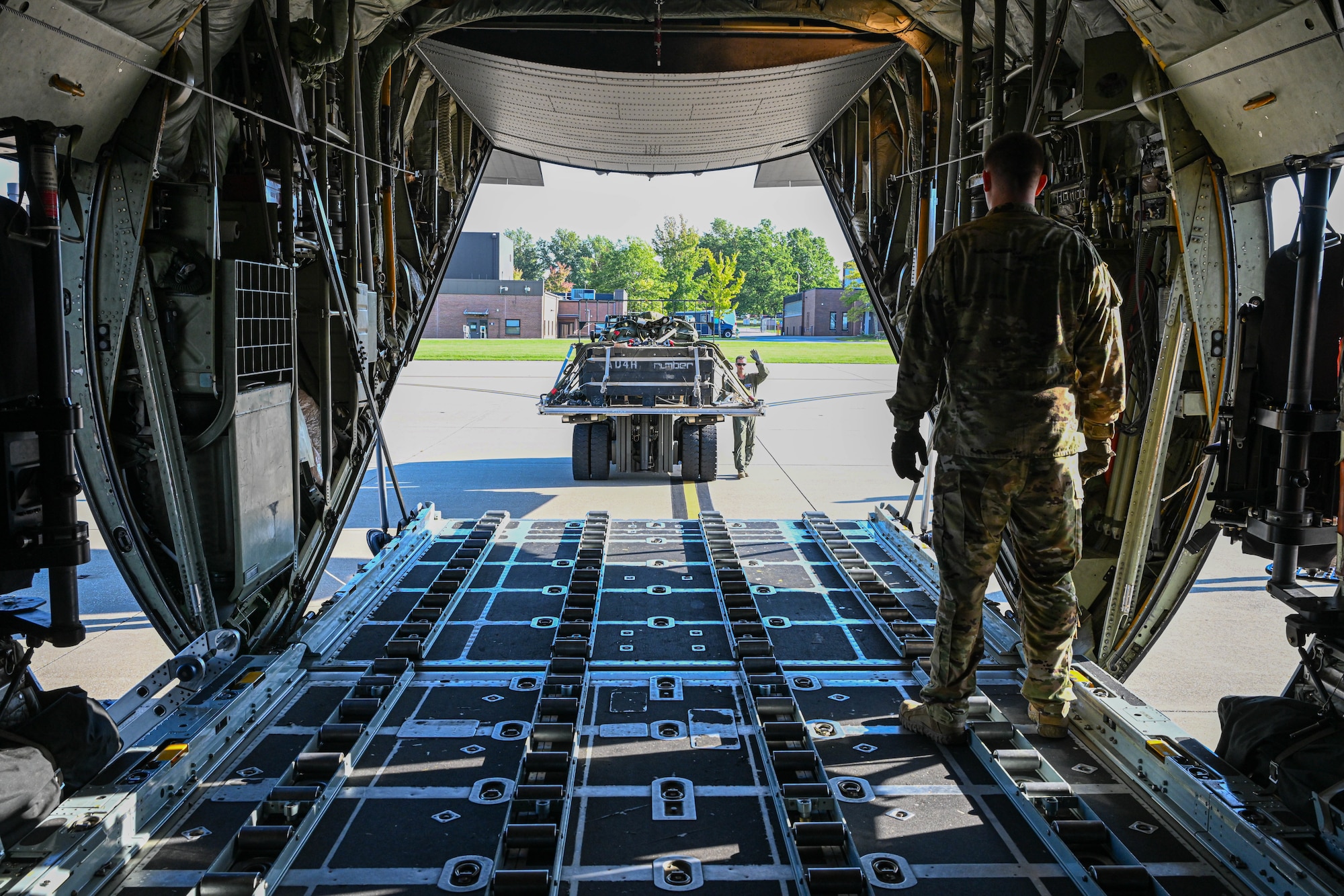 Members of the 76th Aerial Port Squadron prepare to load an airdrop training pallet into a C-130H Hercules aircraft stationed at Youngstown Air Reserve Station, Ohio, Oct. 6, 2024