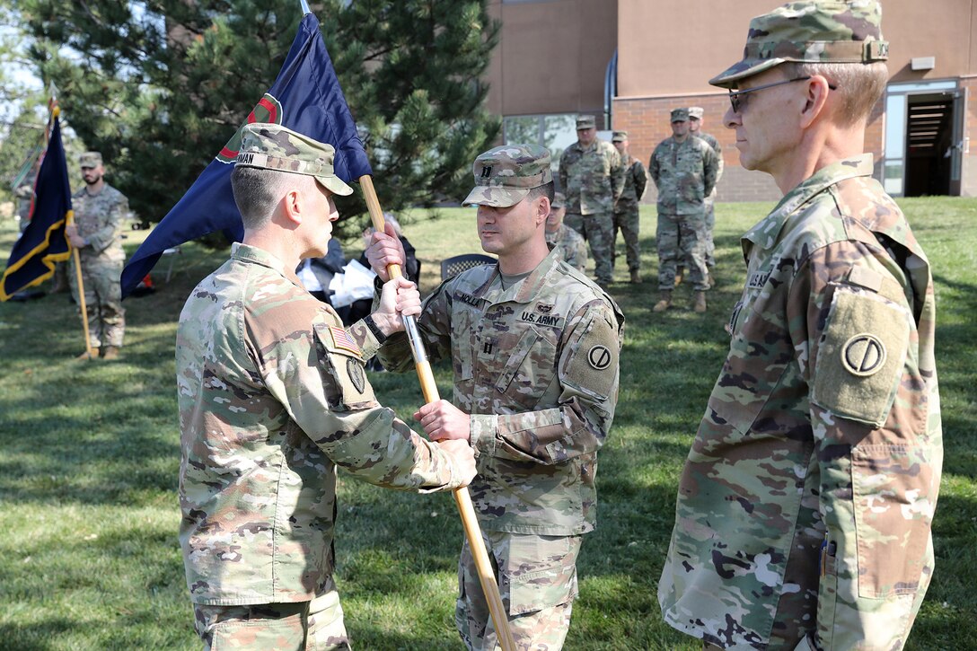 Capt. James Nolla, center, incoming headquarters and headquarters company commander, 85th U.S. Army Reserve Support Command, receives the colors during an assumption of command ceremony on Sunday, October 6, 2024, at the Paul G. Schulstad Army Reserve Center in Arlington Heights, Illinois.